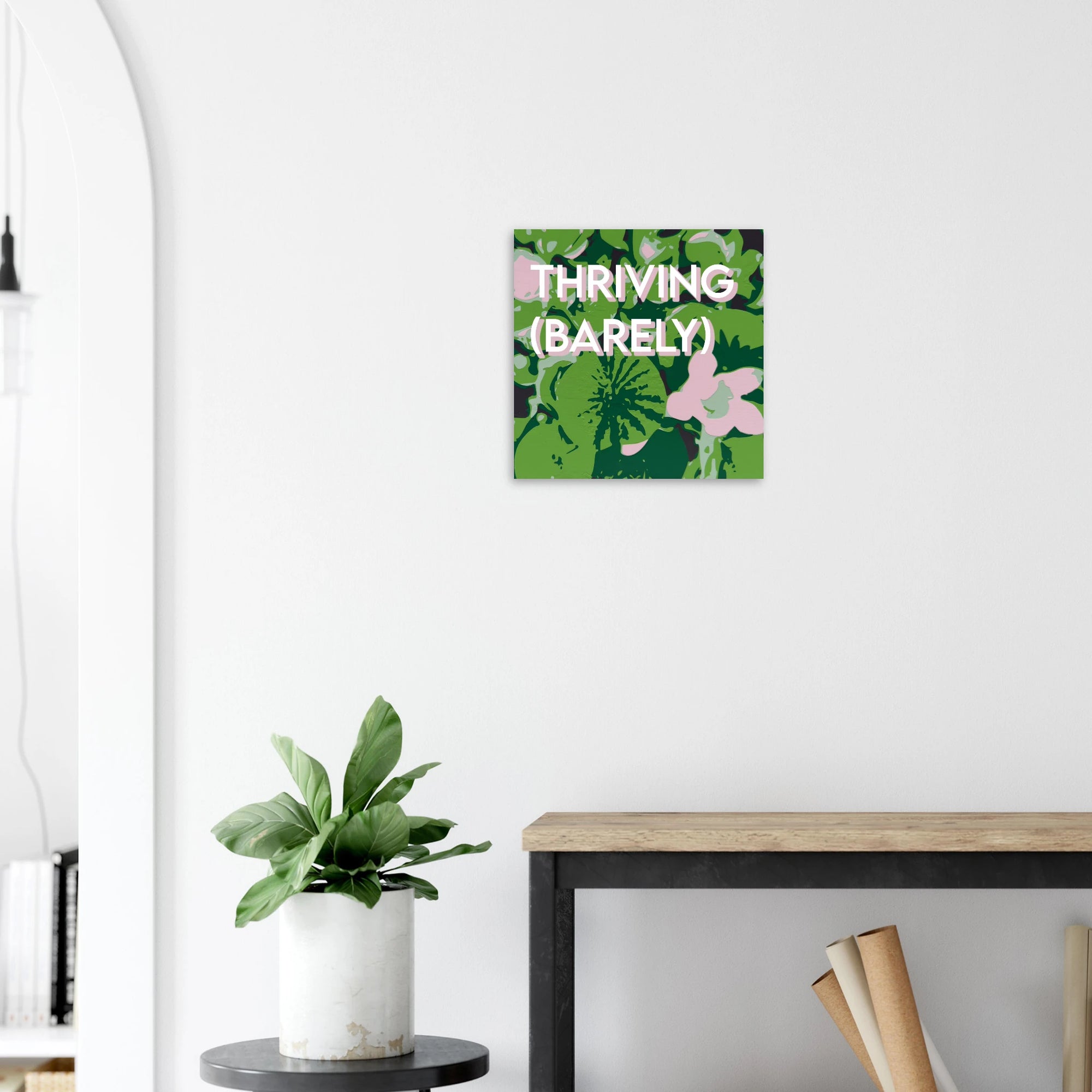 Thriving Barely lily print on textured dark wall above white sofa